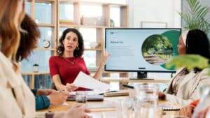 pessoas trabalhando em um escritório passando slides, simbolizando Como o Smallppt Ajuda Você